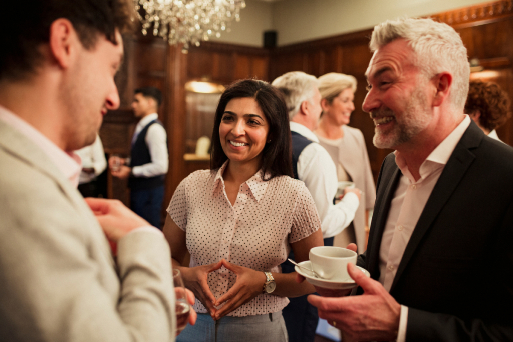 A woman and two men networking at a professional event
